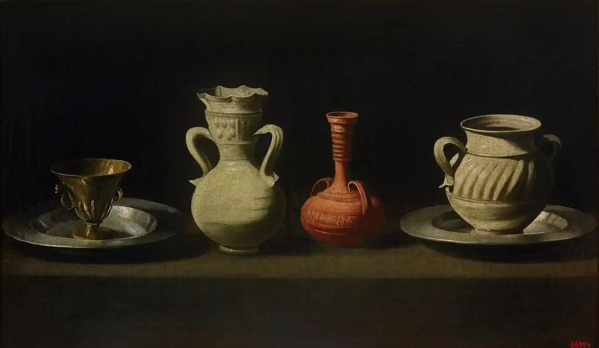 Four vessels — a gilt cup on a pewter plate, a white two-handled jar, a red clay vase and a ribbed white cup — in a row against darkness.