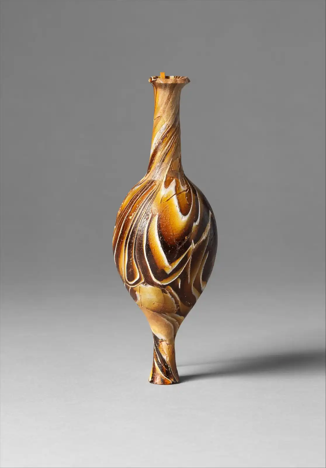 Marbled mosaic-glass perfume bottle with a narrow neck, photographed on a plain ground.